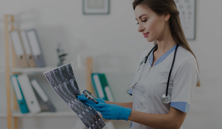 Orthopaedic surgeon examining X-ray results