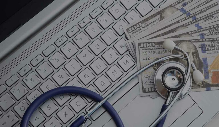 medical billing service companies professionals collaborating on paperwork at a desk.
